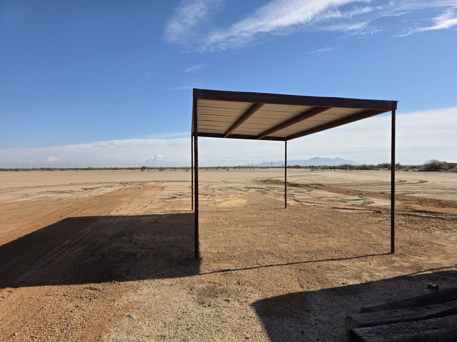 Sun shade structure over the pit area where rock is being added at the Arizona City Flyers field