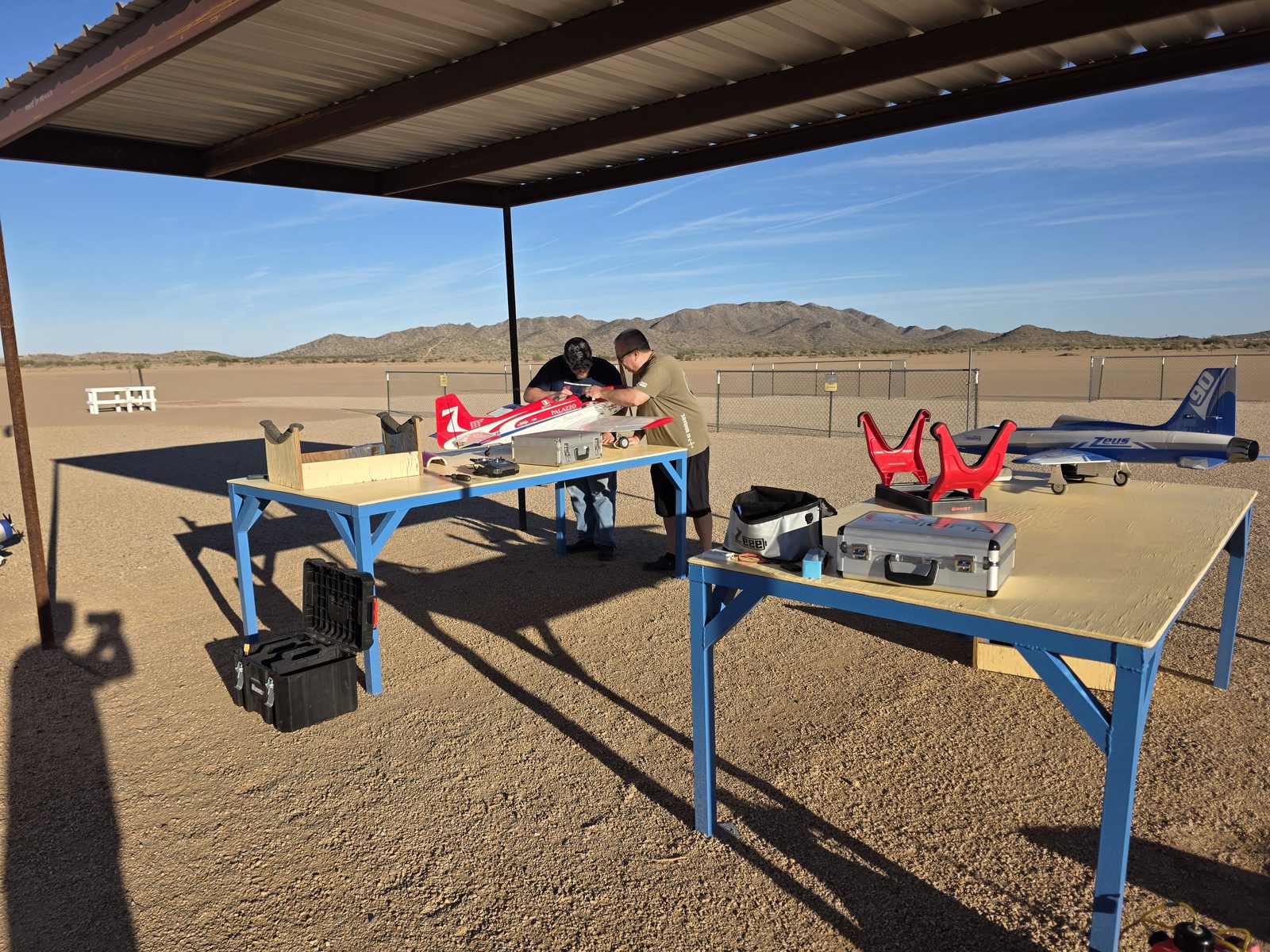 Club members preparing RC airplanes under the new metal sun shade at the Arizona City Flyers field