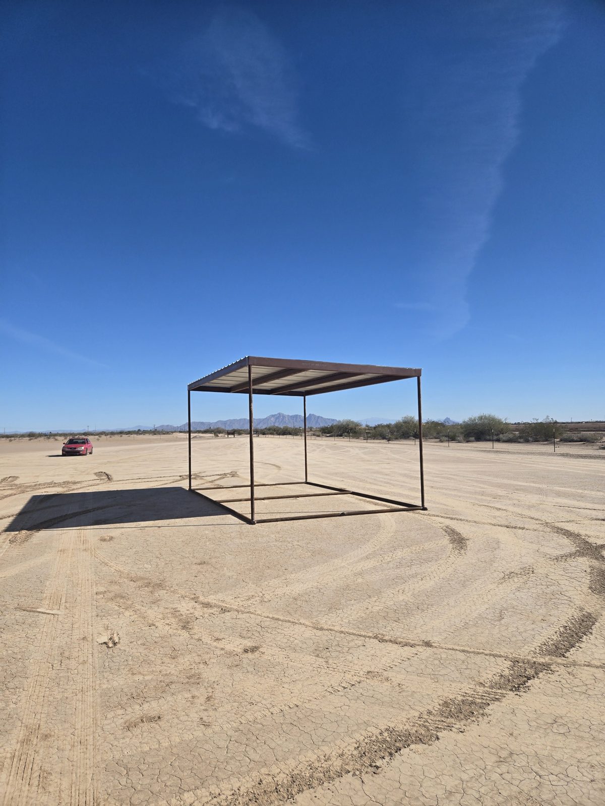 Completed metal sun shade structure with corrugated roof at the Arizona City Flyers desert flying field